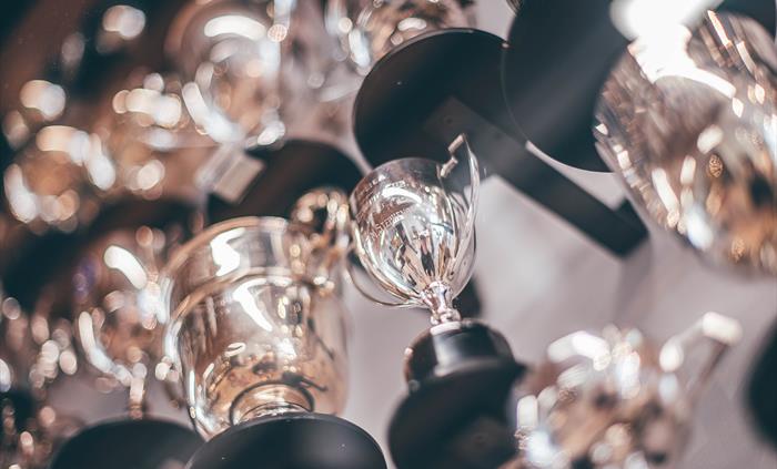 Selection of silver trophies in a display case. Looking up from underneath.